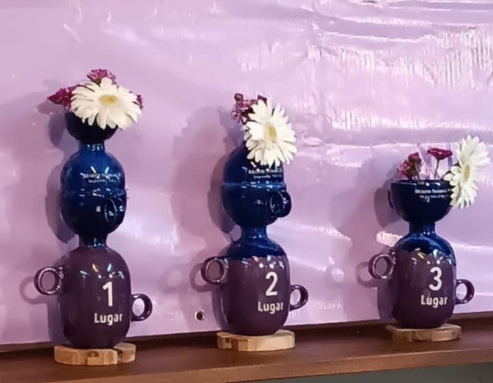 The ceramic first, second and third place trophies, with flowers